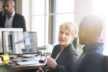 Two financial business people in discussion